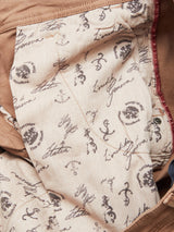 A close-up of the interior fabric reveals a vintage style with tan lining and nautical prints, including anchors, ship wheels, and text like Italia and Genova. Emblem-like graphics complement the comfort stretch design, featuring Brownie Menzo Dobby Chino fabric by Blue de Gênes.