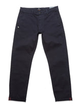 The Menzo Dobby Chino - Dark Navy by Blue de Gênes features a button and zip closure, side pockets, and decorative stitching near the cuffs. With comfort stretch for easy movement, these pants blend modern design with vintage flair, suitable for both formal and casual settings.