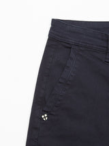 Close-up of Blue de Gênes Menzo Dobby Chino in Dark Navy, featuring a visible side pocket and belt loop for vintage-inspired style. A small triangular patch adds charm. Crafted from comfort stretch fabric, they have a smooth yet slightly textured finish.