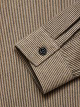 Close-up of the Ginotto Oregon Shirt by Blue de Gênes in brown and black yarn-dye stripe brushed cotton, featuring a long sleeve cuff with a black button.