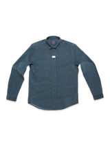 The Enrico Cord Shirt - Blue Pattern by Blue de Gênes is a long-sleeved button-up in dark teal with a subtle floral print. Made from soft baby corduroy, it has a standard collar and a small tag near the top button.