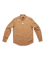 The Enrico Nidos Shirt by Blue de Gênes features a brown, long-sleeve button-up crafted from soft cotton piqué with a collar and logo by the chest on a white background, finished with a stylish garment-dyed touch.