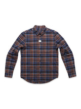 The Zamboni Quadro Shirt by Blue de Gênes is a long-sleeved, button-up with a navy yarn-dye check pattern in blue, brown, and black plaid. It’s made from a winter cotton-linen blend and displayed on a plain white background with a small neck tag.
