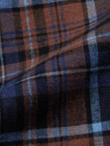 Close-up of the brown and blue plaid on the Zamboni Quadro Shirt in Navy Check by Blue de Gênes, showcasing intersecting lines typical of a yarn-dye check. The cotton-linen blend appears slightly folded, adding depth and shadow.
