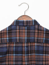 A Zamboni Quadro Shirt by Blue de Gênes, features a navy check yarn-dye pattern with brown, blue, and black lines on a wooden hanger against a white background. The back view highlights its collar and yoke.