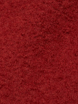 The Pampa Overshirt - Ochre Red by Blue de GĂȘnes features a red, textured fabric resembling fuzzy boiled wool, offering a soft and warm texture ideal for cozy overshirts or blankets.