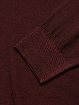 Close-up of the Blue de Gênes Marlon Knit in Prune—a dark brown long-sleeve shirt with raglan sleeves, highlighting the cuffs texture. The finely knit, soft material features a reverse knit pattern suggesting both comfort and style.