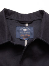 Close-up of the Amos Blazer in dark navy by Blue de Gênes, featuring a size 50 tag. This relaxed-fit cotton canvas blazer combines comfort with timeless style.