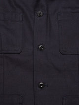 Close-up of the Amos Blazer in dark navy by Blue de Gênes—a cotton canvas blazer with a relaxed fit, three black buttons, and two front chest pockets with visible stitching.