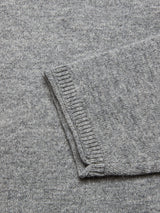Close-up of the Monte AW Knit - Stormy Grey by Blue de Gênes, highlighting a sleeve with ribbed cuffs. Crafted from soft, slightly marled Merino wool, featuring a minimalist design with a textured appearance.