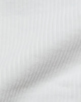 A close-up of the Crivello Cord Shorts in Snow White by Blue de Gênes reveals soft, white cotton corduroy with subtle vertical ridges that capture delicate shadows and highlights.