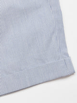 The Elak Riga Shorts by Blue de Gênes feature a fine line cotton fabric with blue and white vertical pinstripes. Neatly hemmed edges enhance the crisp look, with Corozo nut buttons adding elegance—ideal for a relaxed regular fit garment.