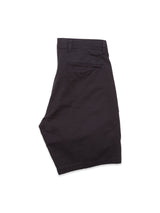 The Menzino Shorts by Blue de Gênes in dark navy are garment-dyed for a unique finish. With belt loops, a button-closure back pocket, and herringbone fabric offering a smooth texture, they are neatly folded against a plain white background.