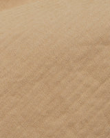 Close-up of the Menzino Shorts - Khaki by Blue de Gênes, featuring a beige garment-dyed fabric with diagonal ribbed texture and fine lines, creating a soft woven appearance reminiscent of chino shorts.