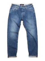 The Giacomo Maracas Jeans by Blue de Gênes feature Italian craftsmanship in blue denim with a straight-leg cut, button and zipper fly, front pockets, belt loops, a slightly faded look, and folded cuffs.