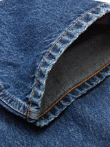 A close-up of the Giacomo Maracas Jeans by Blue de Gênes highlights Italian craftsmanship with visible orange stitching on blue denim. The Vintage Wash fabric features a classic indigo texture, while the pockets interior displays a lighter weave for a relaxed fit.
