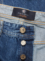 Close-up of Giacomo Maracas Jeans in vintage wash with metallic buttons and a Blue de Gênes label, highlighting Italian craftsmanship. The denim features visible stitching details, and the buttons also display the brand name.