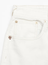 Close-up of Giacomo Bull WTH - White Denim by Blue de Gênes, highlighting the upper part with a front pocket and metal shield emblem. Made in Italy, featuring subtle diagonal stitching and metallic rivets for added flair.