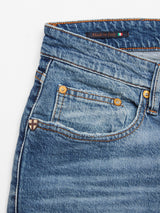 Close-up of Vinci Super Used Jeans by Blue de Gênes shows the pocket area. The comfort stretch denim features a faded, textured look with visible stitching. A small metal button adorns the pocket, and a label reads Made in Italy with the Italian flag, showcasing style and ease.