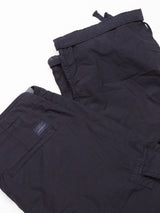 A folded pair of Mustang Cargo Pant in navy by Blue de Gênes, made from parachute cotton with utility pockets and a subtle logo on one pocket, is set against a plain white background.