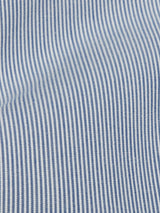 Close-up of the Palto Riga Chino by Blue de Gênes, featuring blue and white vertical pinstripes on cotton. The evenly spaced stripes create a uniform pattern, while the slightly wavy fabric adds texture and depth, reminiscent of a relaxed fit garment.
