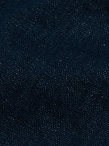 Close-up of dark blue Vinci Topaz Jeans by Blue de Gênes, crafted in Italy, highlighting the textured weave and subtle color variations of the denim fabric.