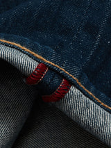 Close-up of Blue de Gênes Vinci Topaz Jeans - Rinse Wash, made in Italy. Displaying dark denim with orange stitching and red selvedge detail, the interior features a lighter striped texture and Comfort Stretch Denim for ultimate comfort.