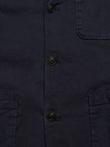 A close-up of the Blue de Gênes Gabbiano Dobby Blazer in dark navy highlights its five black buttons and a right-side chest pocket. The fabric offers a subtly textured finish with cotton comfort stretch for both ease and elegance.