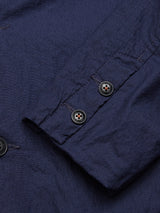 Close-up of the Gervaso Tarlo Blazer - Navy by Blue de Gênes, showcasing its tailored details with a wrinkled navy cotton fabric, visible stitching, buttonholes, and two corozo buttons on the sleeve cuff.