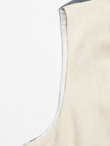 A close-up of the Pantella Desk Gilet by Blue de Gênes showcases its beige and gray fabric with visible seams. The white lining, featuring vertical stripes, is crafted from a luxurious Cotton/Linen blend, perfectly capturing the craftsmanship and texture.