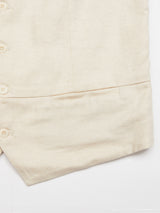 A close-up of the Pantella Desk Gilet - Natural by Blue de Gênes reveals a textured weave with Corozo buttons on the left side. Only the lower part is visible, highlighting its Cotton/Linen blend, clear stitching, and smooth finish.
