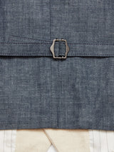 Zoom in on the Pantella Desk Gilet - Natural by Blue de Gênes, featuring blue fabric with a metal buckle. Underneath, a white garment with vertical stripes and a textured cream band is visible, showcasing the cotton/linen blends texture and detail.