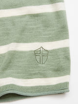 Close-up of the Blue de Gênes Monte Stripe Knit - Green Bay jumper, featuring green and white horizontal stripes and an embroidered shield. The cotton/linen blend crewneck showcases a knit texture for both comfort and style.
