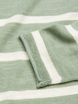 Close-up of the Monte Stripe Knit - Green Bay by Blue de Gênes, featuring a green crewneck with white stripes. The folded sleeve cuff showcases the knitted texture and roll-rib hem of this cotton/linen blend garment.