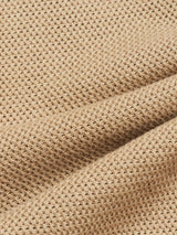 The Filo Knit Polo in Khaki by Blue de Gênes features a close-up of its beige, textured waffle knit fabric with grid-like patterns. Made from 100% cotton, it boasts a tactile, woven look with soft shadows and hints of retro repeat stitch in its design.