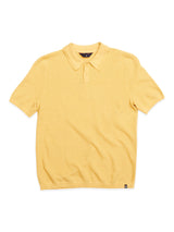 The Filo Knit Polo - Yellow Grain by Blue de Gênes is a 100% cotton shirt featuring a retro repeat stitch pattern, short sleeves, collar, and button placket.
