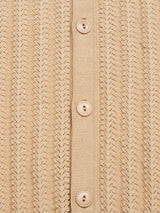 A close-up of the Compra Open Polo Knit - Khaki by Blue de Gênes, showcasing beige organic cotton with vertical ribbed patterns and four matching buttons aligned vertically on a fabric strip. The texture and uniformity of the design are prominent.
