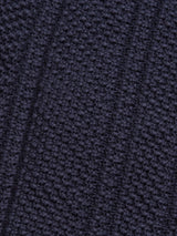 Close-up of the textured Achille Cardigan in navy by Blue de Gênes, showcasing visible small loops and diagonal line patterns. The fabric looks soft and dense, highlighting exquisite weaving details perfect for a stylish cotton cardigan.