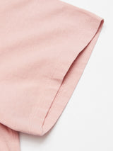 Close-up of the Salty Logo T-Shirt in Porcelain Pink by Blue de Gênes against a white background, highlighting the sleeves hem and showcasing the cotton-jersey fabric texture and stitching.