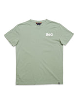 The Salty Logo T-Shirt - Green Bay by Blue de Gênes is a light green, regular fit cotton-jersey with short sleeves and a round neck. BdG is embroidered in white on the left chest and features a small black tag at the bottom edge.