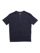 The BdG S/S Grandad in navy by Blue de Gênes is a dark blue short-sleeve grandad t-shirt with a three-button placket featuring corozo nut buttons, laid flat on a white background.