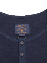 Close-up of a navy cotton slub yarn BdG S/S Grandad shirt by Blue de Gênes, size large. It features a neck label and eco-friendly round neckline with two Corozo nut buttons.
