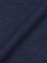 Close-up of BdG S/S Grandad - Navy by Blue de Gênes, featuring dark blue cotton slub yarn fabric with a diagonal fold. The texture is soft with a heathered pattern, and the lighting enhances the fine weave and subtle blue shade variations.