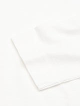 Close-up of the BdG Grandad - Snow White by Blue de Gênes, folded neatly on a plain background to highlight its smooth texture and subtle weave, reminiscent of classic appeal.