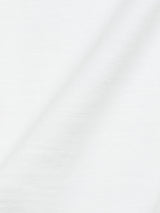 A close-up of Blue de Gênes BdG Grandad in Snow White shows light gray fabric with a cotton slub-like texture. It has a subtle diagonal crease, slightly rough feel, faint horizontal lines, and soft matte finish reminiscent of a classic grandad t-shirt.