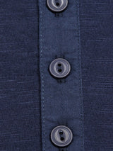The BdG Grandad - Navy by Blue de Gênes features a close-up of textured navy cotton slub fabric with a vertical placket adorned by five glossy four-hole Corozo nut buttons.