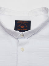 The Basso Dob Shirt - Blue Water by Blue de Gênes is a textured cotton jacquard button-up with a mandarin collar and two buttons, featuring a black label inside that highlights the elegance of European tailoring.