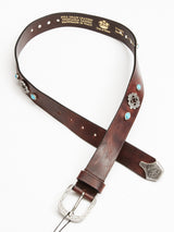 The Blue de Gênes Western Studded Belt in dark brown features silver and turquoise studs and a detailed silver buckle. Crafted from full-grain leather, hand-made in Italy emphasizes its superb craftsmanship.