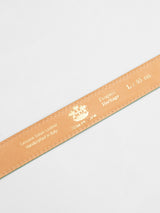 Close-up of a tan Belt with gold text: Genuine Italian Leather, Handmade in Italy. Sizes: L/95 cm. Small logo and Heritage visible. Product Name: Suede Belt - Green Bay; Brand Name: Blue de Gênes on white background.