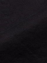 Close-up of Blue de Gênes Vinci Venom Blk Jeans in dark denim shows the comfort stretch fabric’s textured knit and fine weave, with a diagonal seam for added detail and a soft, slightly stretchy appearance.